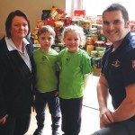 Centre Director Kym, children and Captain Nathan Hodges from The Salvation Army